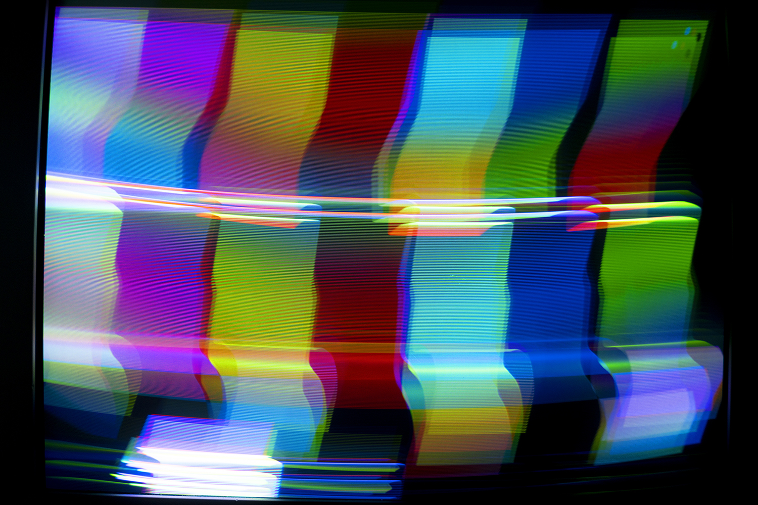 Photo of SMPTE color bars heavily manipulated electromagnetically through the CRT Flux Phaser.