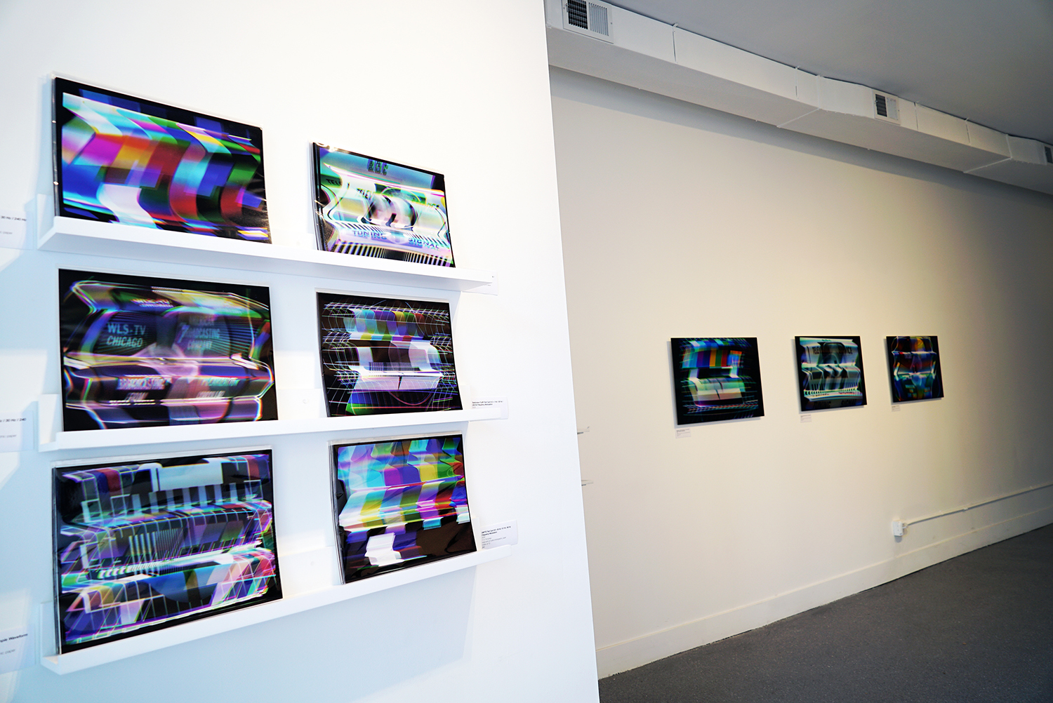 6 paper prints of imagery processed on the CRT Flux Phaser on a wall shelf in the foreground with 3 face-mounted prints in the background.