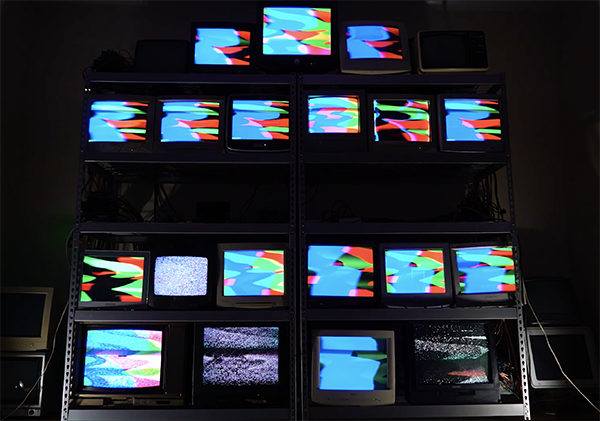 photo of a stack of 19 CRT monitors showing bright colors generated by the RGB.VGA.VOLT software